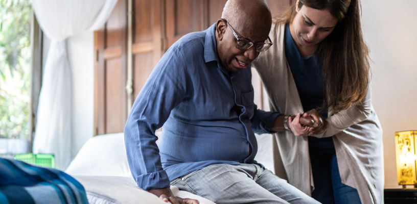 Woman helping an elderly man