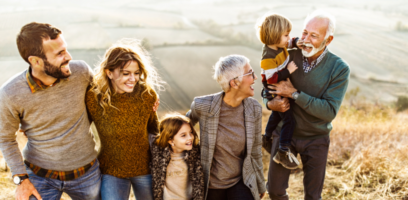 Family smiling outside